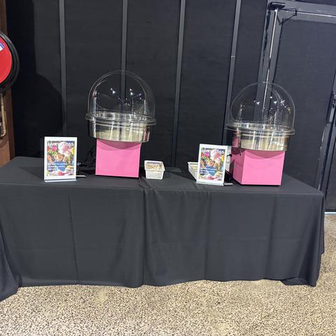 Two fairy floss machines set up at an indoor event