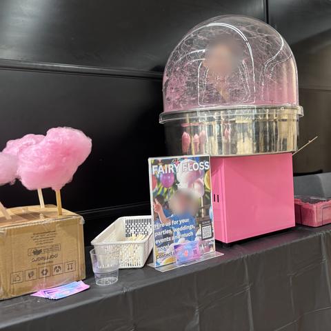 Pink fairy floss ready to go beside our fairy floss machine