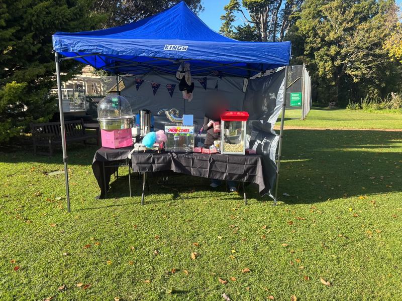 The AZ Fairy Floss stall set up with the fairy floss machine and colourful flavours
